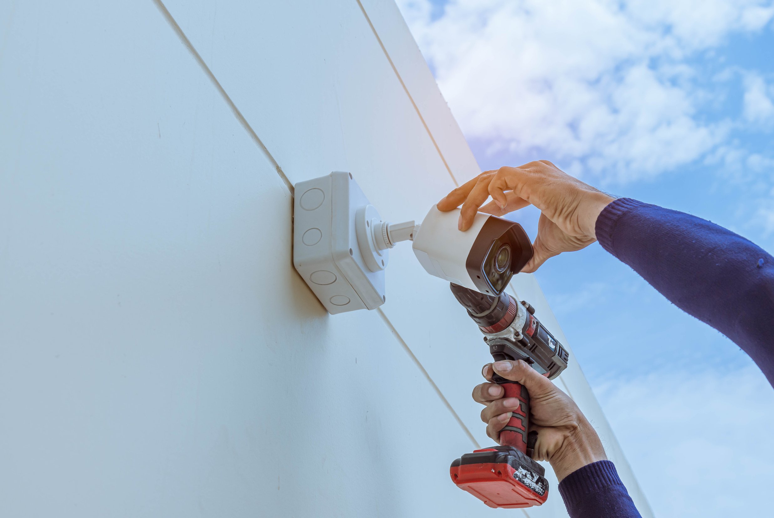 Technician installing CCTV camera for security